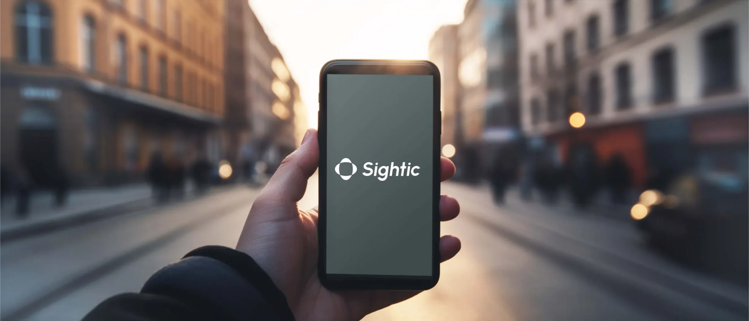 Person holding a phone with the Sightic logo on